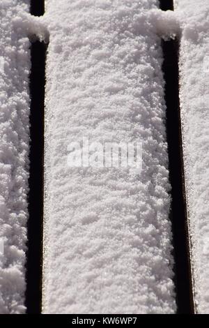 close-up melting snow, Snow-covered wood terrace floor background Stock Photo
