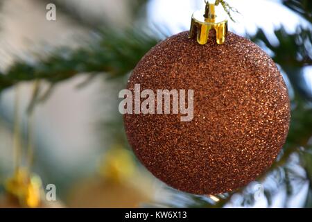glittering golden ball decorated on Christmas tree Stock Photo