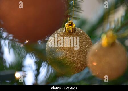 glittering golden ball decorated on Christmas tree Stock Photo