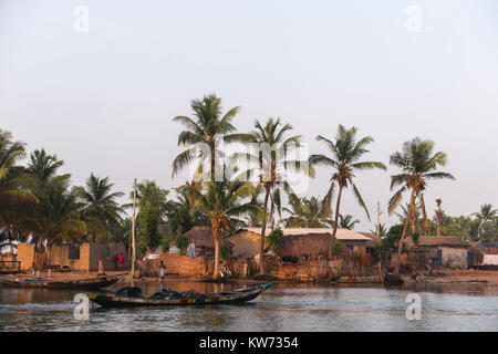 In the village of Ada Foah people live very close to the riverside, Volta River, Ada Foah, Greater Accra Region, Ghana, Africa Stock Photo
