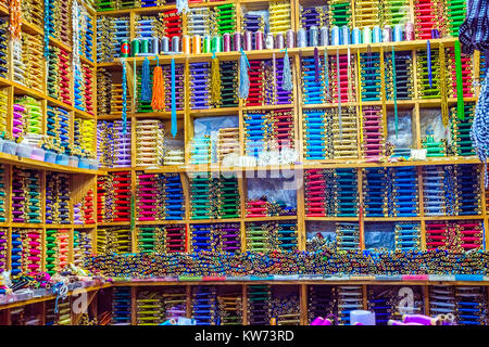 Many colorful threads on the shelfs in a workshop Stock Photo