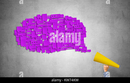 Close of man making announcement in paper trumpet Stock Photo