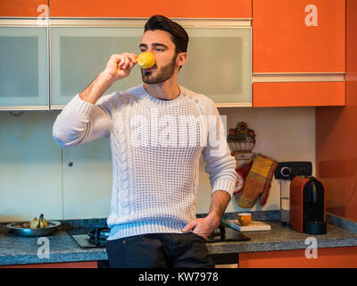 Young Man Drinking from Espresso Coffee Cup Stock Photo
