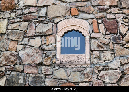 Isolated window on a stone wall Stock Photo