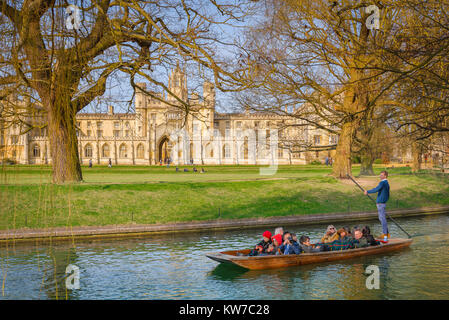 Punting Cambridge UK, on a spring morning in Cambridge, UK, tourists take a trip in a punt on the River Cam, gliding past St John's College.
