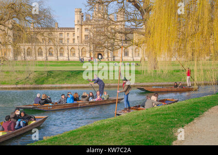 Cambridge UK punting, on a spring morning in Cambridge, UK, tourists take a trip in a punt on the River Cam, gliding past St John's College.