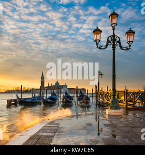 Gondolas on the Grand Canal at sunrise in Venice, Italy