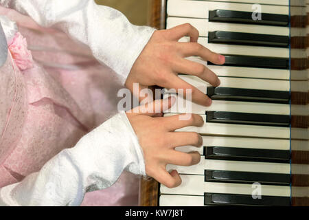 Children's hands on piano keys Stock Photo