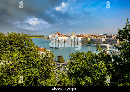 The Danube River with tour boat, Chain Bridge, Pest and the Parliament building taken from the Buda Castle District in Budapest Hungary Stock Photo