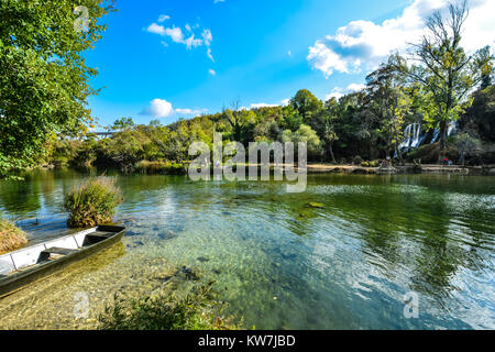 The Kravice or Kravica falls and park near Mostar on the Trebizat River in Bosnia and Herzegovina. A lush garden, with waterfalls and a small boat Stock Photo