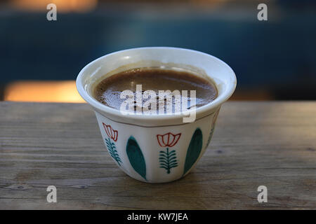 A traditonal Lebanese coffee cup on wooden pane. Stock Photo