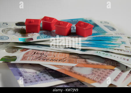 5, 10 and 20 Pound notes randomly arranged with red monopoly hotels Stock Photo
