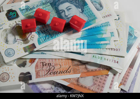 5, 10 and 20 Pound notes randomly arranged with red monopoly hotels Stock Photo