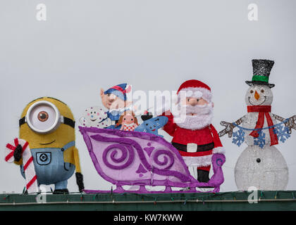 several christmas characters from christmas tv shows on display on a roof Stock Photo