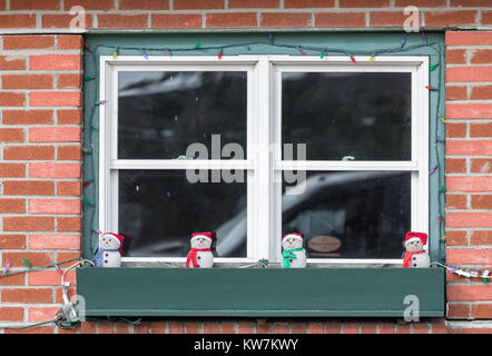 christmas street decorations in a window box in front of a window Stock Photo