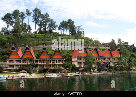 Row of traditional batak houses on the Samosir island, Indonesia Stock Photo