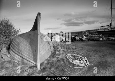 Old Upturned Herring Boats used as fishermans stores on the island of Lindisfarne on the Northumbrian Coast, UK,GB, England. Stock Photo