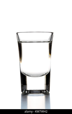 German hard liquor Korn Schnapps in shot glass over white background Stock Photo