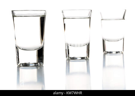 German hard liquor Korn Schnapps in shot glasses over white background Stock Photo