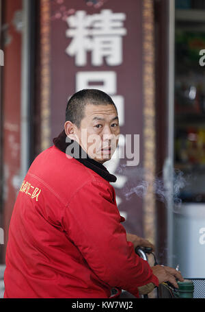 Zhangye,China - October 20,2017: Chinese man catches tickets at a box office on October 20, China. Stock Photo