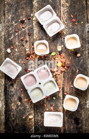Various fruit yoghurts. On a wooden background. Stock Photo