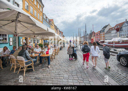 Waterfront restaurants at Nyhavn, a 17th century harbor district in the center of Copenhagen and currently a popular tourist attraction . Stock Photo