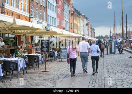 Waterfront restaurants at Nyhavn, a 17th century harbor district in the center of Copenhagen and currently a popular tourist attraction . Stock Photo