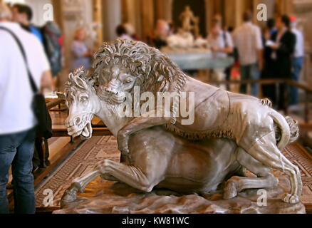 Lion hunting. Ancient sculpture of a lion viciously attacking a horse, in the Vatican museum, Rome, Italy. Stock Photo