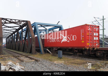HAMBURG, GERMANY - DECEMBER 20, 2016: Container train on a railway bridge in the Hamburg harbor area