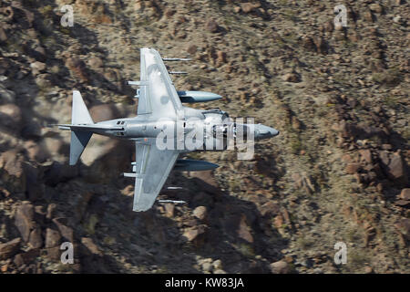 USMC AV-8B Harrier II V/STOL Ground Attack Jet Flying At Low Level And High Speed Through A Desert Valley In California, USA. Stock Photo