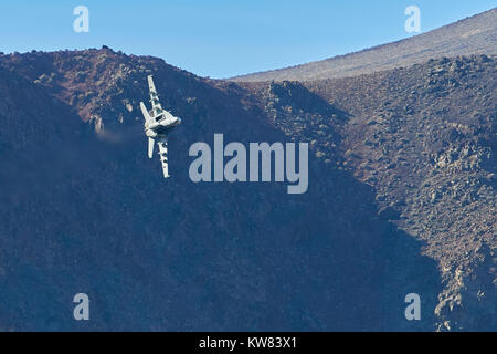 US Navy F/A-18 Super Hornet Jet Fighter Flying At Low Level Through Rainbow Canyon California. Stock Photo