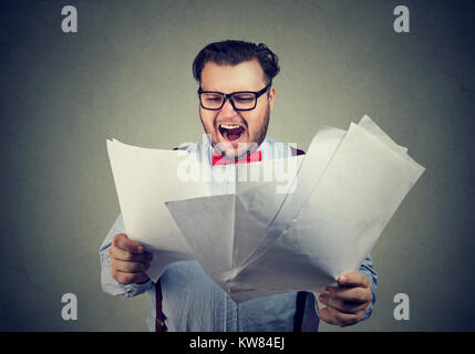 Chubby businessman exploring papers of contract and screaming in stress. Stock Photo