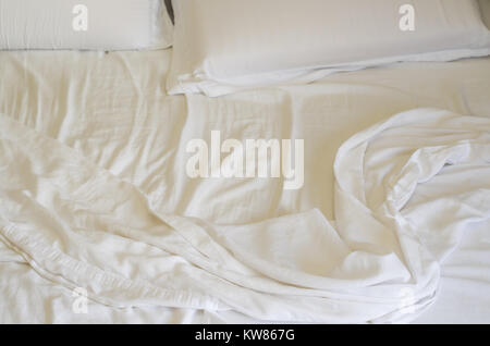 Great concept of bed messy, unkempt, white bed, crumpled sheet. Stock Photo