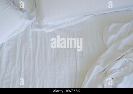 Great concept of bed messy, unkempt, white bed, crumpled sheet. Stock Photo