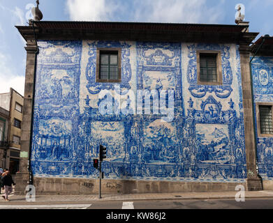 Porto, Portugal, August 14, 2017: Exterior walls of the Porto's Chapel of Souls are virtually entirely covered with blue and white ceramic tiles, depi Stock Photo