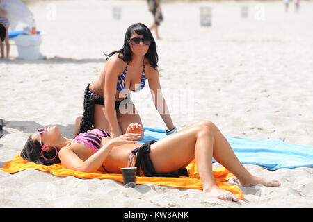 MIAMI, FL - Summer 2010: Angelina Pivarnick, Sammi Giancola on the set of Jersey Shore season 2 in Miami. Jersey Shore is an American reality television series that follows the lives of eight housemates Nicole 'Snooki' Polizzi, Jenni 'Jwoww' Farley, Mike 'The Situation' Sorrentino, Ronnie Ortiz-Magro, Vinny Guadagnino, Paul 'Pauly D' DelVecchio, Sammi 'Sweetheart' Giancola, and Angelina Pivarnick. The show debuted amid large amounts of controversy regarding the use of the words 'Guido/Guidette,' portrayals of Italian-American stereotypes.The series garnered record ratings for MTV, making it th Stock Photo