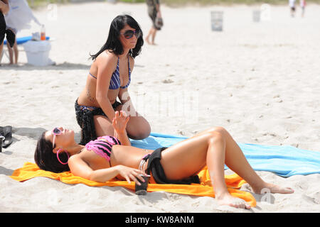 MIAMI, FL - Summer 2010: Angelina Pivarnick, Sammi Giancola on the set of Jersey Shore season 2 in Miami. Jersey Shore is an American reality television series that follows the lives of eight housemates Nicole 'Snooki' Polizzi, Jenni 'Jwoww' Farley, Mike 'The Situation' Sorrentino, Ronnie Ortiz-Magro, Vinny Guadagnino, Paul 'Pauly D' DelVecchio, Sammi 'Sweetheart' Giancola, and Angelina Pivarnick. The show debuted amid large amounts of controversy regarding the use of the words 'Guido/Guidette,' portrayals of Italian-American stereotypes.The series garnered record ratings for MTV, making it th Stock Photo