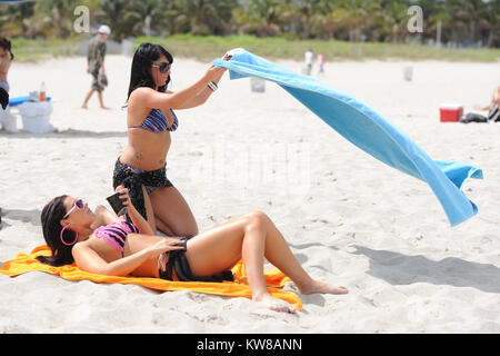 MIAMI, FL - Summer 2010: Angelina Pivarnick, Sammi Giancola on the set of Jersey Shore season 2 in Miami. Jersey Shore is an American reality television series that follows the lives of eight housemates Nicole 'Snooki' Polizzi, Jenni 'Jwoww' Farley, Mike 'The Situation' Sorrentino, Ronnie Ortiz-Magro, Vinny Guadagnino, Paul 'Pauly D' DelVecchio, Sammi 'Sweetheart' Giancola, and Angelina Pivarnick. The show debuted amid large amounts of controversy regarding the use of the words 'Guido/Guidette,' portrayals of Italian-American stereotypes.The series garnered record ratings for MTV, making it th Stock Photo