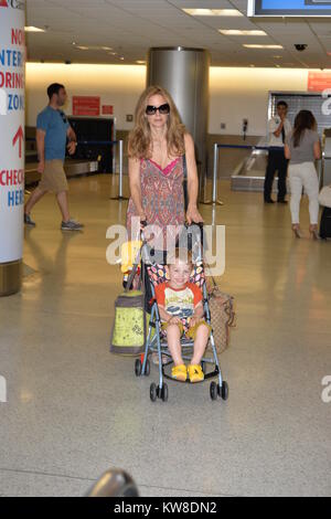 MIAMI, FL - JUNE 10: (EXCLUSIVE COVERAGE)  Actress Kelly Preston arrives with her son Benjamin Travolta at Miami International Airport on June 10, 2013 in Miami, Florida  People:  Kelly Preston Benjamin Travolta Stock Photo