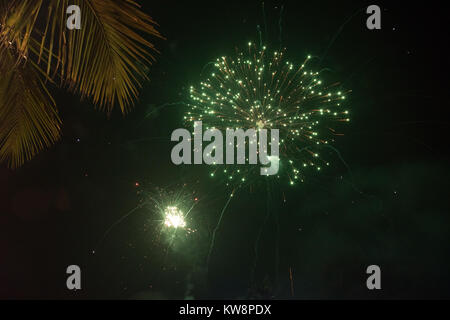 Benaulim beach, Goa, India. Monday 1st January 2018. New years day fireworks to celebrate at gala dinner in Goa beachside. Palm trees form the backdrop for the fireworks on another warm night Stock Photo