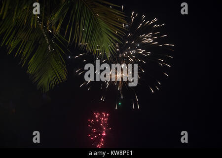 Benaulim beach, Goa, India. Monday 1st January 2018. New years day fireworks to celebrate at gala dinner in Goa beachside. Palm trees form the backdrop for the fireworks on another warm days Credit: WansfordPhoto/Alamy Live News Stock Photo