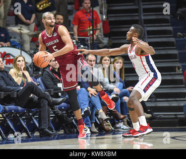 The Ball. 31st Dec, 2017. MS, USA; South Carolina, FRANK BOOKER (5), tries to save the ball from going out, as Ole' Miss guard, DEANDRE BURNETT (1), tries to get at the ball. The Ole' Miss Rebels defeated the South Carolina Gamecocks, 74-69. Kevin Langley/CSM/Alamy Live News Stock Photo
