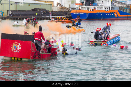 Poole, Dorset, UK. 1st Jan, 2018. The New Years Day Bath Tub Race takes place following a backlash in social media that the event would have to be cancelled due to Health & Safety concerns. Hundreds turn out to watch the event despite the wet weather, as a variety of unusual craft take to the water to race, with participants having fun throwing eggs and flour, firing water cannons and capsizing competing craft. Credit: Carolyn Jenkins/Alamy Live News Stock Photo