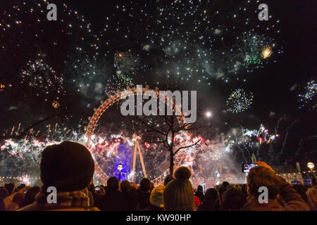 London, UK. 1st Jan, 2018. Revellers crowd along the embankment to watch the fireworks shoot from the London Eye as part of the New Year's Eve celebrations. Credit: Bradley Smith/Alamy Live News Stock Photo