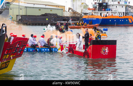 Poole, Dorset, UK. 1st Jan, 2018. The New Years Day Bath Tub Race takes place following a backlash in social media that the event would have to be cancelled due to Health & Safety concerns. Hundreds turn out to watch the event despite the wet weather, as a variety of unusual craft take to the water to race, with participants having fun throwing eggs and flour, firing water cannons and capsizing competing craft. The Royal Wedding carriage! Credit: Carolyn Jenkins/Alamy Live News Stock Photo