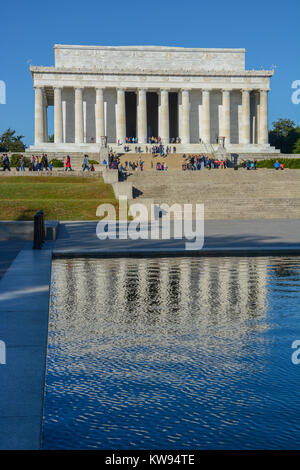 Portrait orientation of the Lincoln Memorial building with reflection in reflecting pool and some tourists, Washington DC, USA Stock Photo