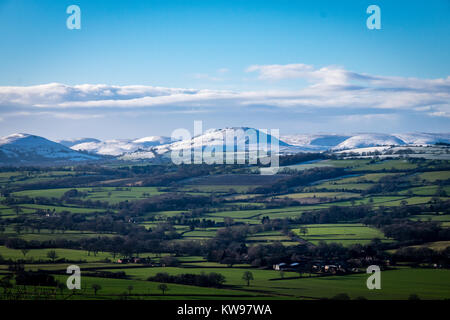 Snow covered mountains of Caer Caradoc and the Long Mynd that overlook Church Stretton Stock Photo