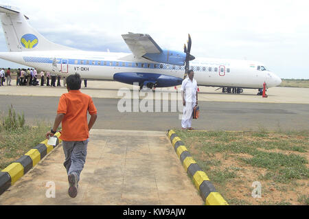 Boy running with boarding pass in hand to aeroplane Stock Photo