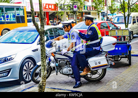 Motorcycle police sharing a motorcycle in Taicang, China. Stock Photo