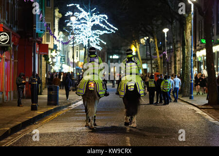 Two mounted police officers patrol the street Stock Photo